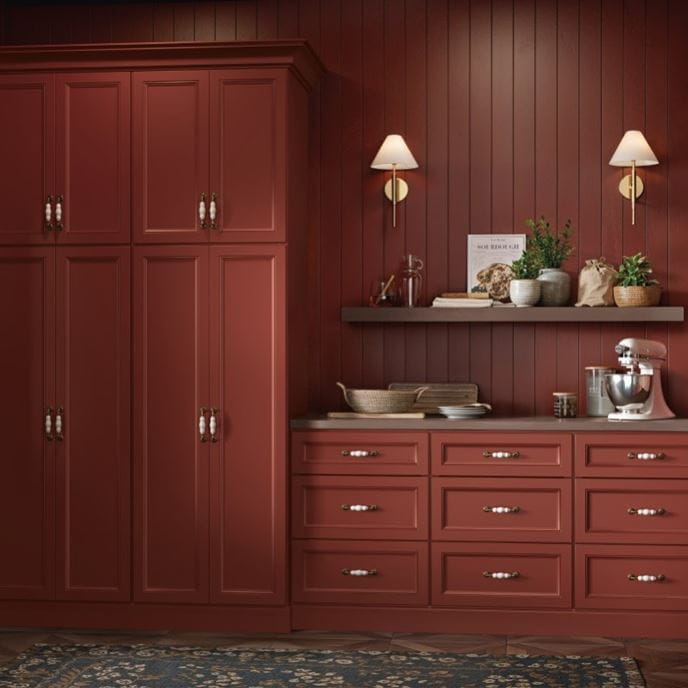Warm, red cabinetry in a painted butler's pantry