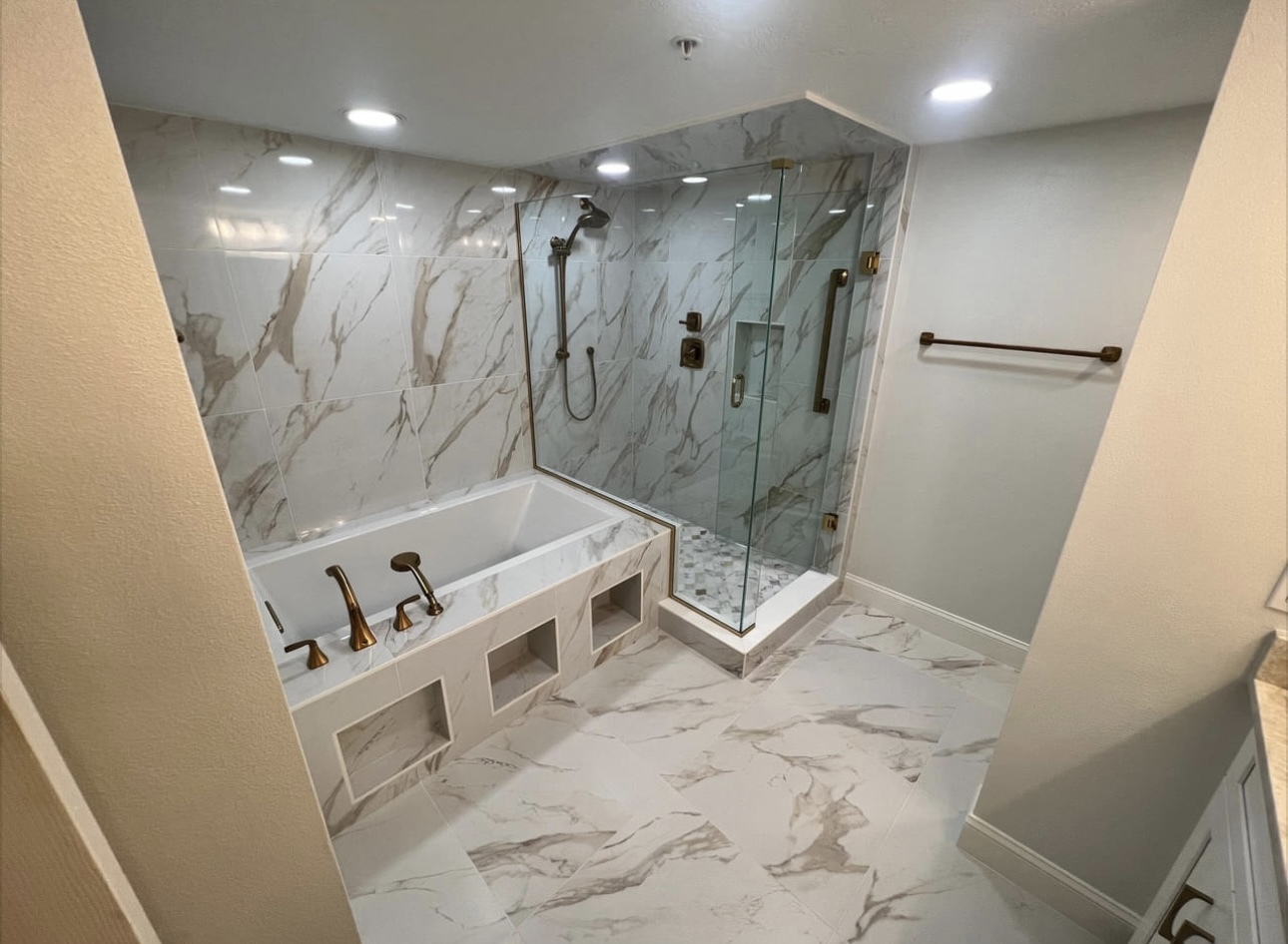 Bathroom with a remodeled shower, tile, and bathtub