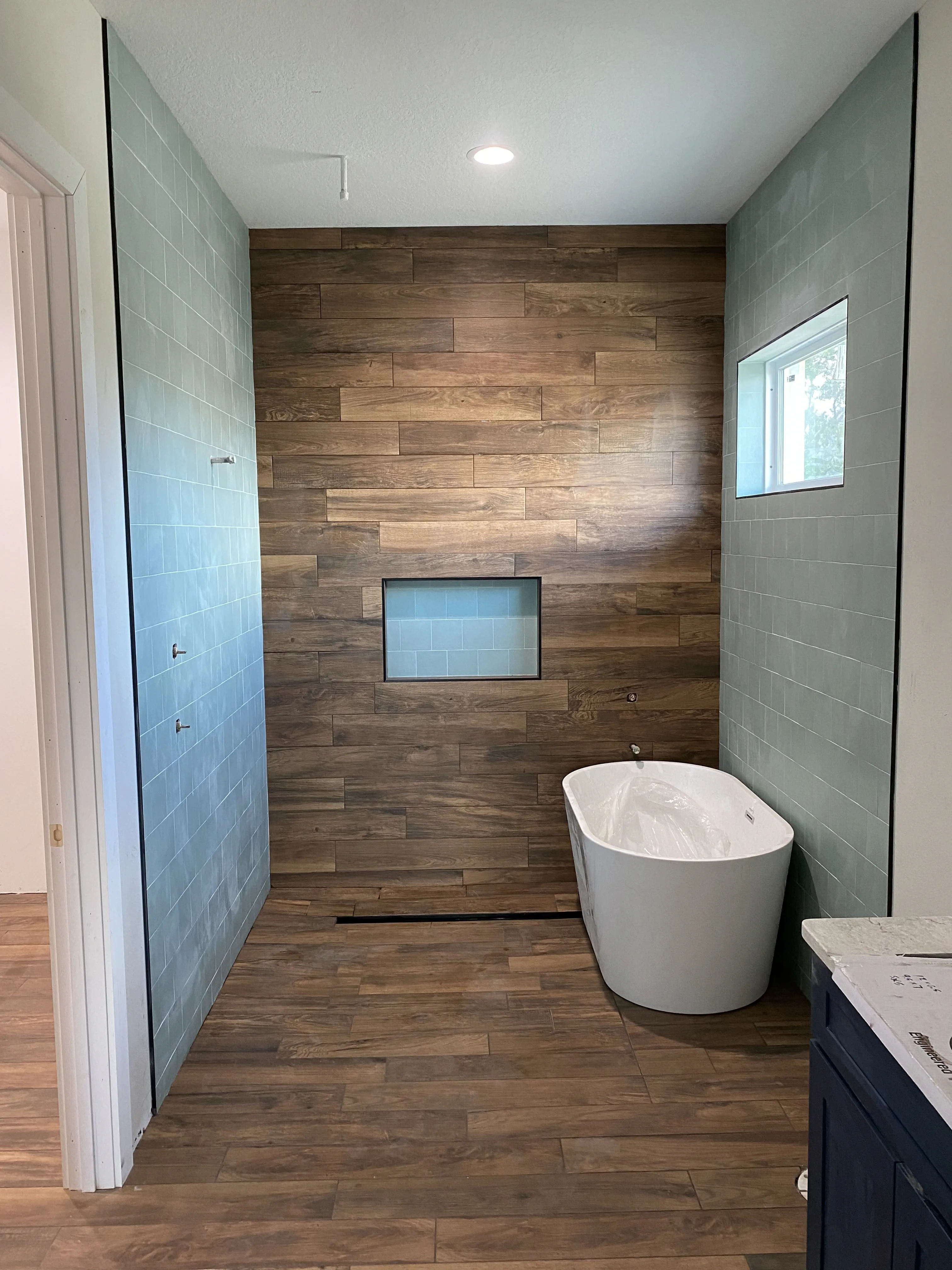 Remodeled bathroom with tile and bathtub